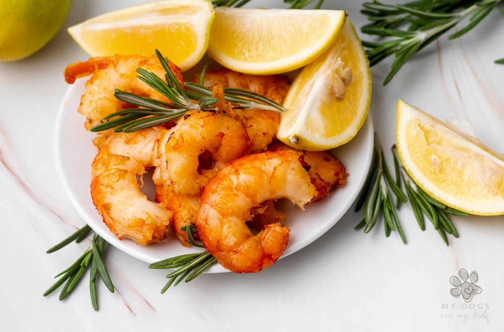 steamed shrimp on a plate with lemon slices and herbs