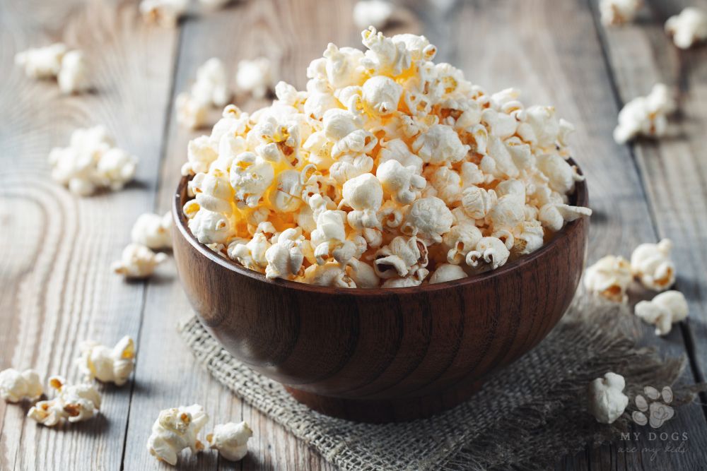 wooden bowl of salted popcorn on a  wooden table