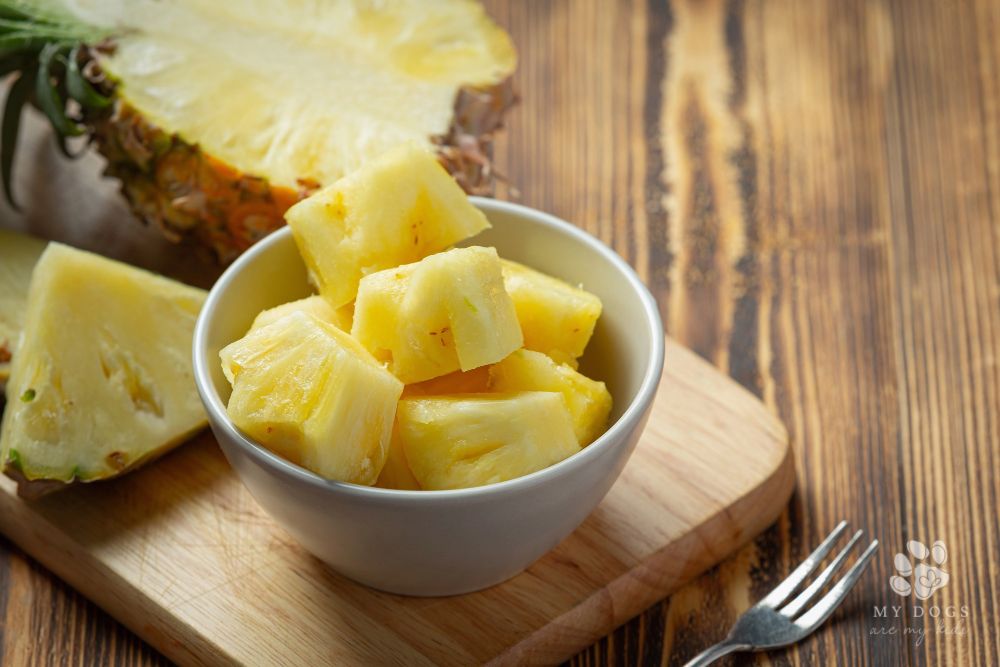 Fresh cut pineapple on dark wooden surface